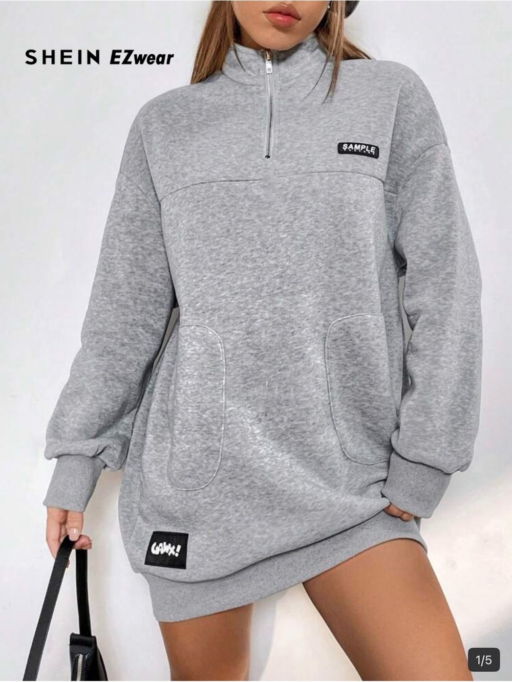 An oversized grey half-zip sweatshirt